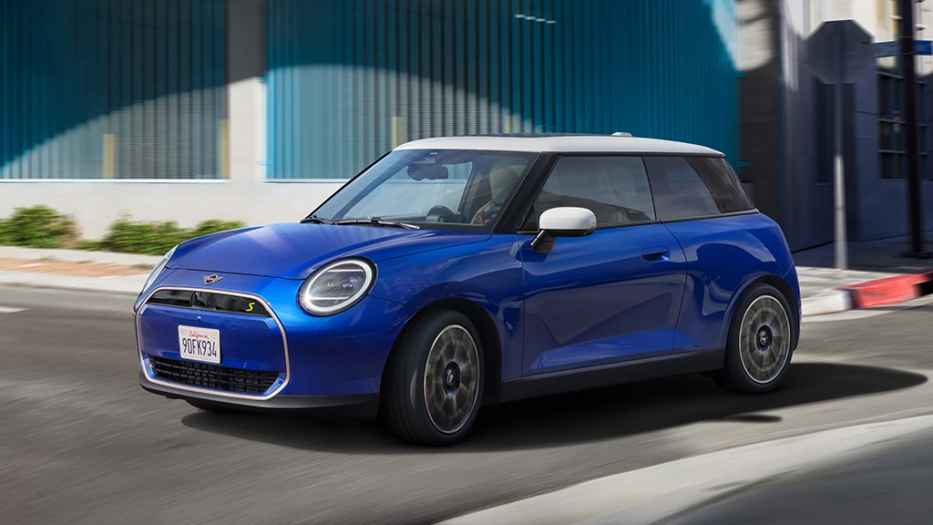 MINI Cooper S in Blazing Blue Metallic driving along an urban street.